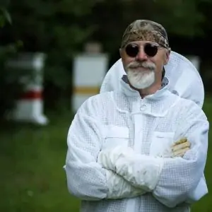 Beekeeper in ventilated suit